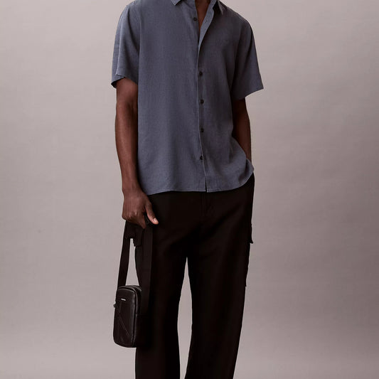 Calvin Klein slim reporter bag – front emblem logo detail view